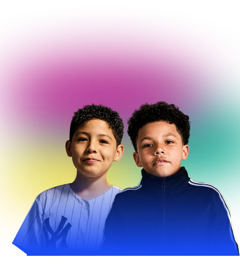 Two boys smiling, the one wearing white shirt and the other one is wearing a black jacket.
